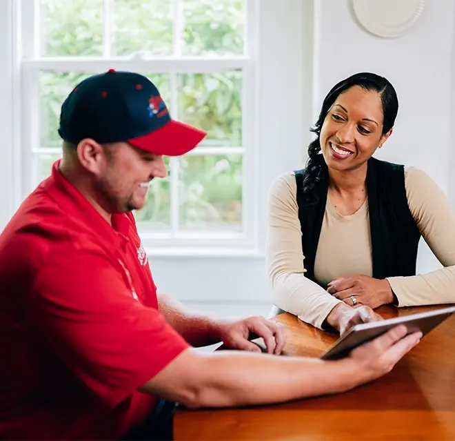 A Rainbow Restoration representative discusses property restoration services with a homeowner in Winder, GA.