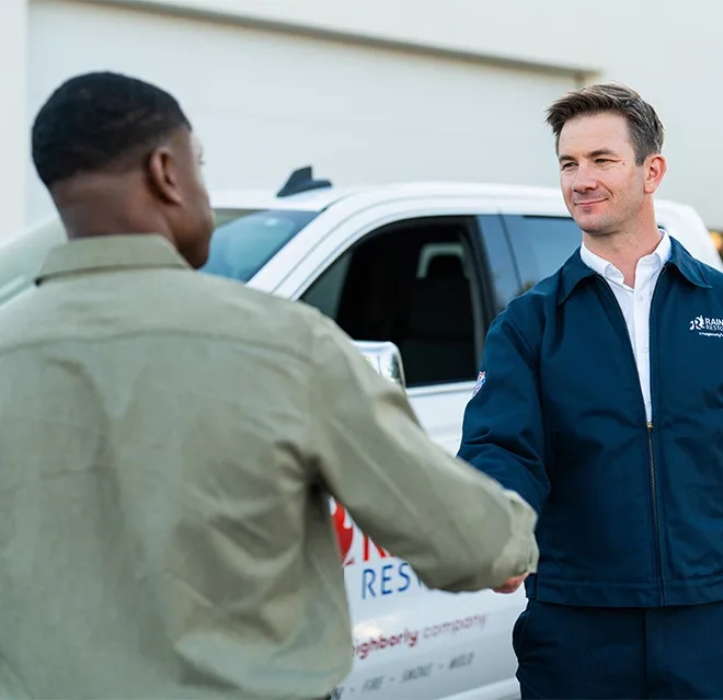 Rainbow Restoration’s emergency response team member greets a property owner in Spartanburg, SC.