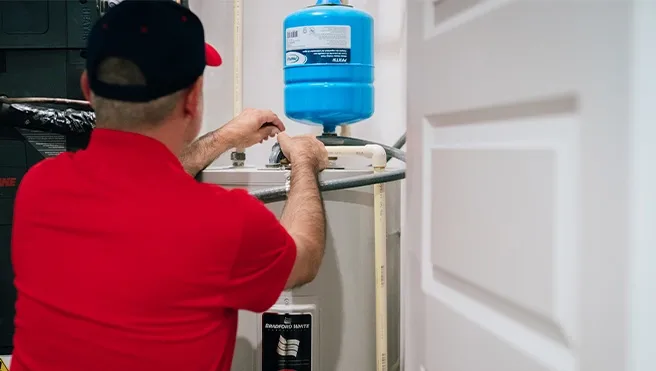 A Rainbow Restoration expert checks a water heater at a Bluffton, SC, home.