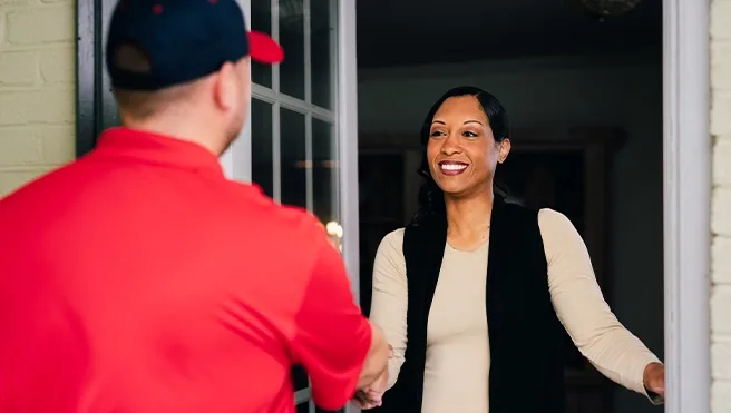 A member of Rainbow Restoration’s emergency property restoration service team greets an Alamance, NC, homeowner.