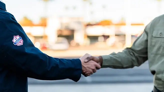 A Rainbow Restoration representative shakes hands with a property owner who has called for help with emergency restoration services in Dickinson, TX.