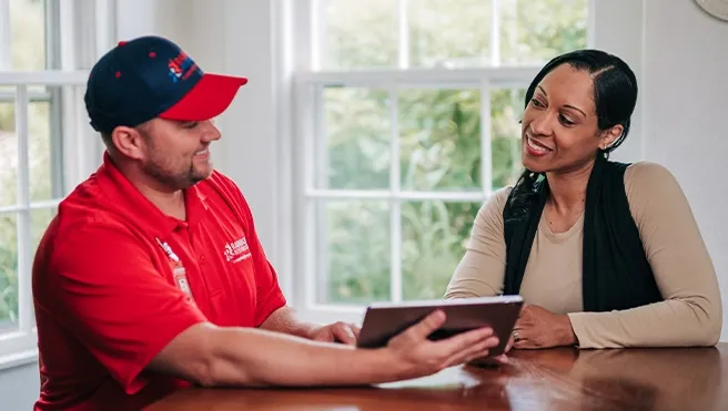 A Rainbow Restoration team member going over a damage assessment document with a homeowner in Cayce, SC.