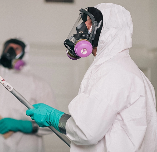 A Rainbow Restoration service professional wearing a biohazard suit.