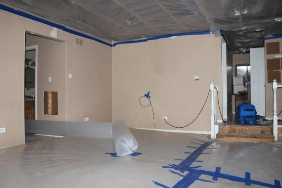A room in a home being restored and cleaned after water damage.