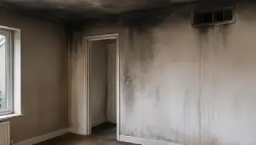 Smoke and soot damage stain the walls and ceiling of a Bristol home after a fire.