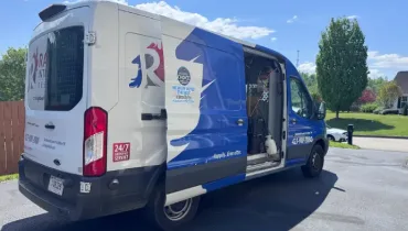Rainbow Restoration service van parked outside a Johnson City home for a water damage restoration response.