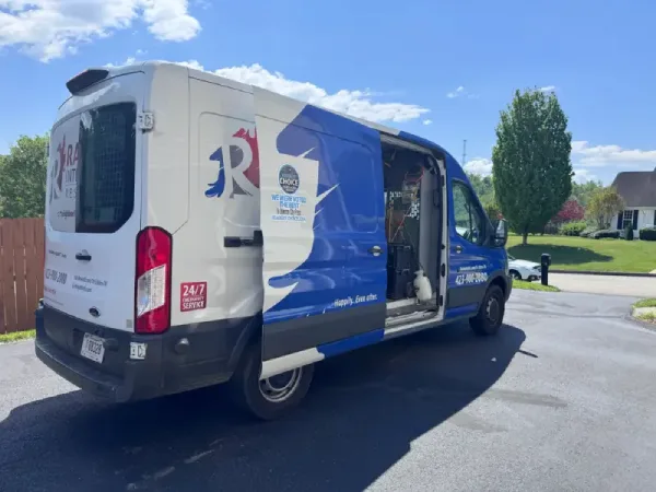 Rainbow Restoration service van parked outside a Johnson City home for a water damage restoration response.