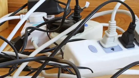 Tangled mess of cords and outlets.